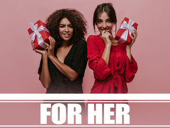 Two women holding gift boxes on a pink background.