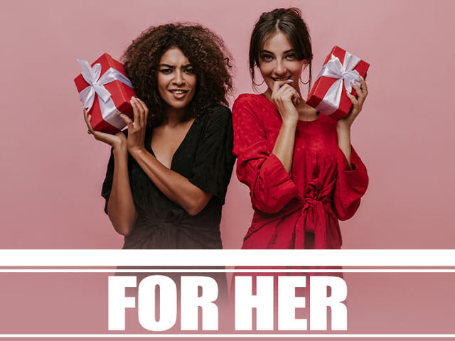 Two women holding gift boxes on a pink background.