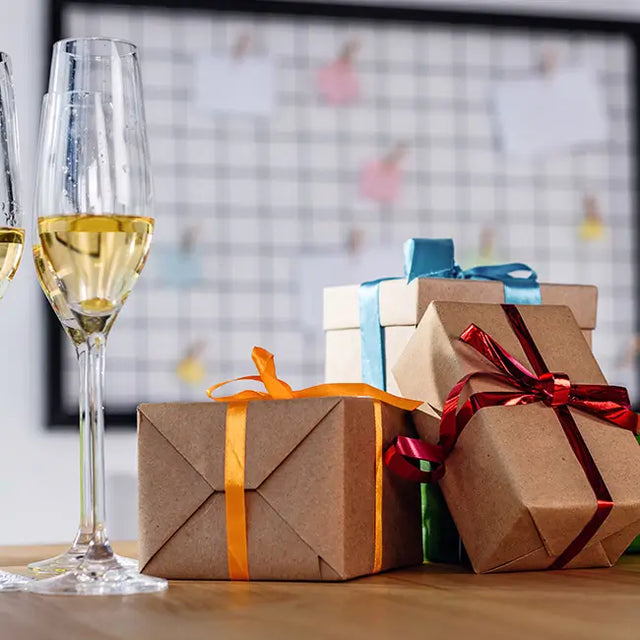 A close-up view of champagne glasses and gift boxes.