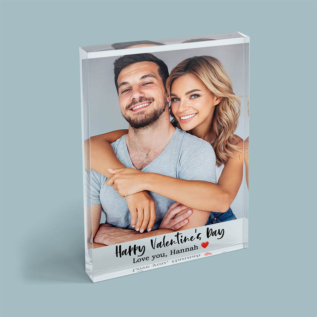 An acrylic block featuring a photo of two people hugging each other against a green background.