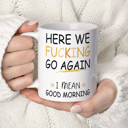 Person holding a mug with humorous text against a white background