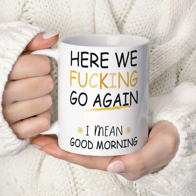 Person holding a mug with humorous text against a white background