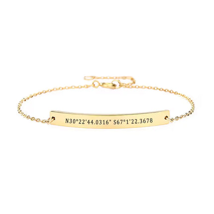A personalised bracelet featuring engraved gold coordinates