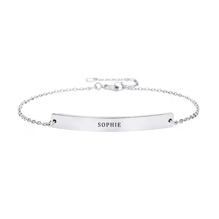 A personalised silver bracelet with an engraved name.