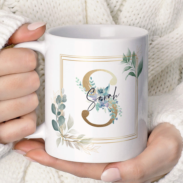 A cozy scene of a person holding a personalized floral mug, showcasing its elegant design