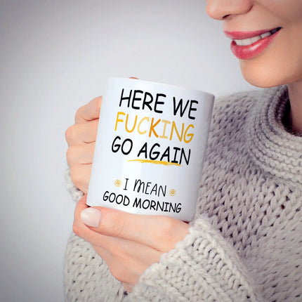 Person holding a mug with humorous text design.