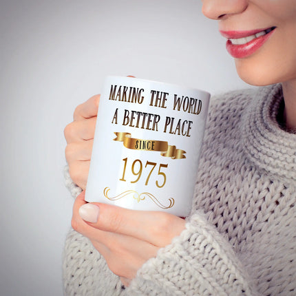 Person holding a stylish white mug with a positive message, wearing a cozy sweater