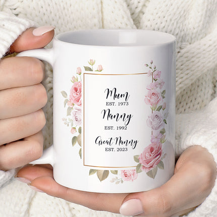 Woman holding a custom floral mug with "Mum, Nanny, Great Nanny" and establishment years printed on it.