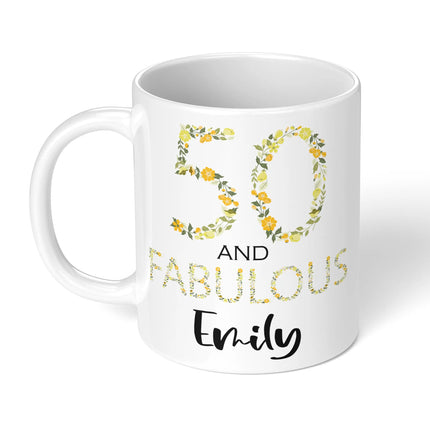 White mug with floral design and text '50 and fabulous Emily' on a white background