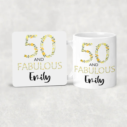 Two white mugs with floral '50 and Fabulous Emily' text on a light gray background
