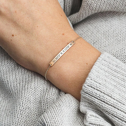 A woman wearing a personalised bracelet on her wrist.