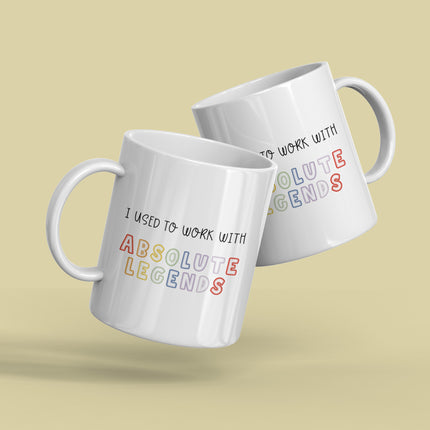 Two white mugs with humorous text design on a beige background