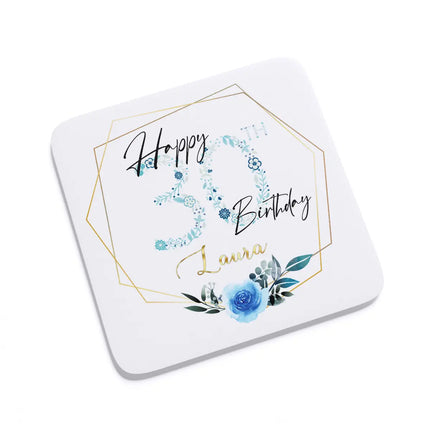 Image of a blue floral coaster with the text "Happy 30th Birthday" printed on it, designed as a gift.