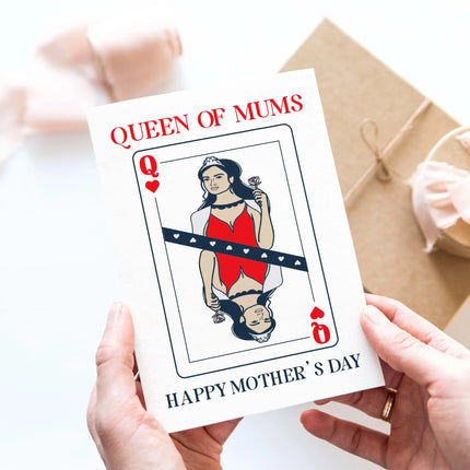 Hands holding a Queen of Mums Mother's Day Card featuring a queen of hearts illustration.