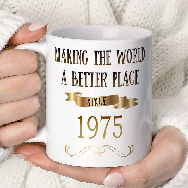 Close-up of a person holding a white ceramic mug with a stylish design.