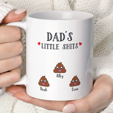 A white coffee mug personalised with white turd emojis on it.