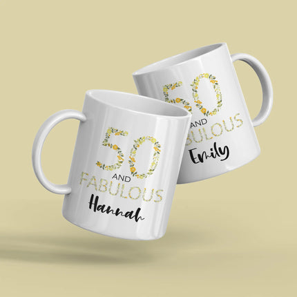 Two white mugs with floral designs and names on a beige background